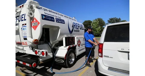 Commercial oil tanker truck at a refueling station managing a Fuel Delivery